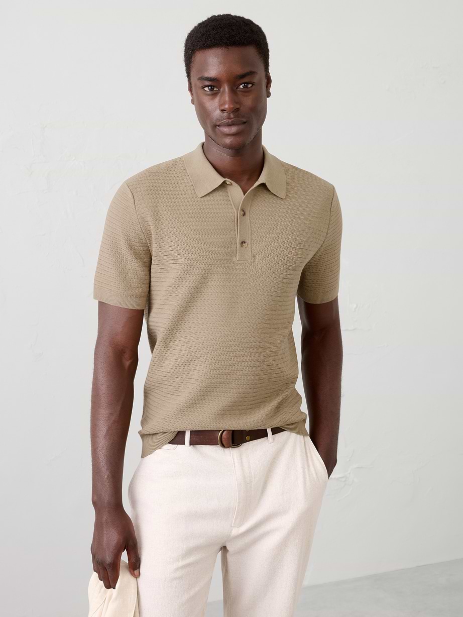 Man in tan polo and white pants.
