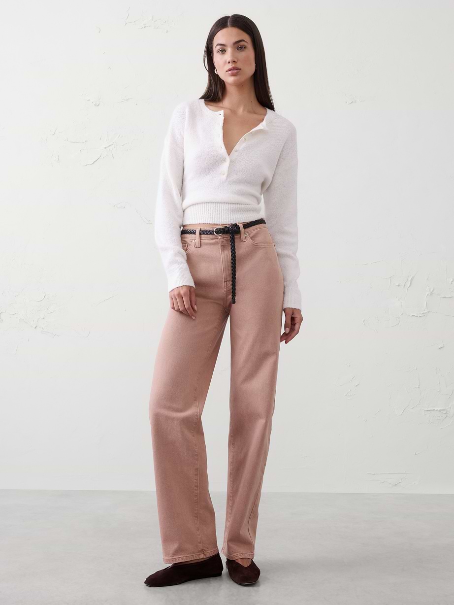 Woman in white top and pink jeans. 