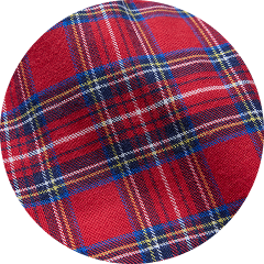 Close-up of red tartan plaid fabric with blue, white, and yellow stripes.