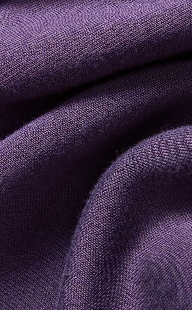 Close-up of folded purple knit fabric showing a soft, textured surface.