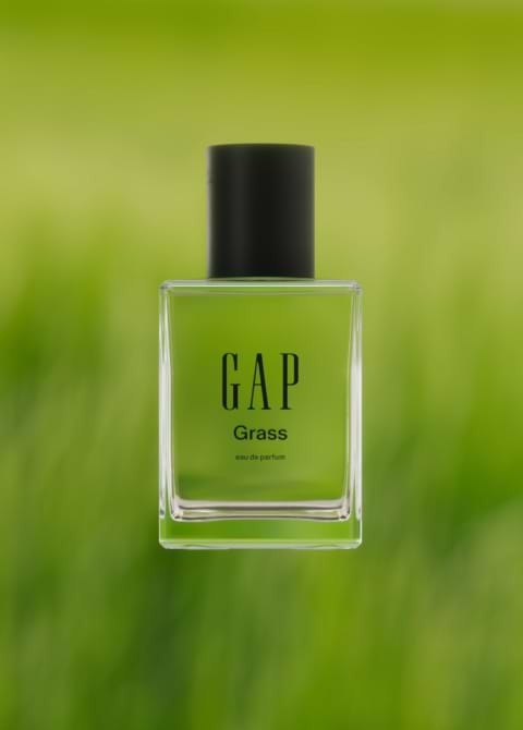 a bottle of gap grass perfume sitting on a green background