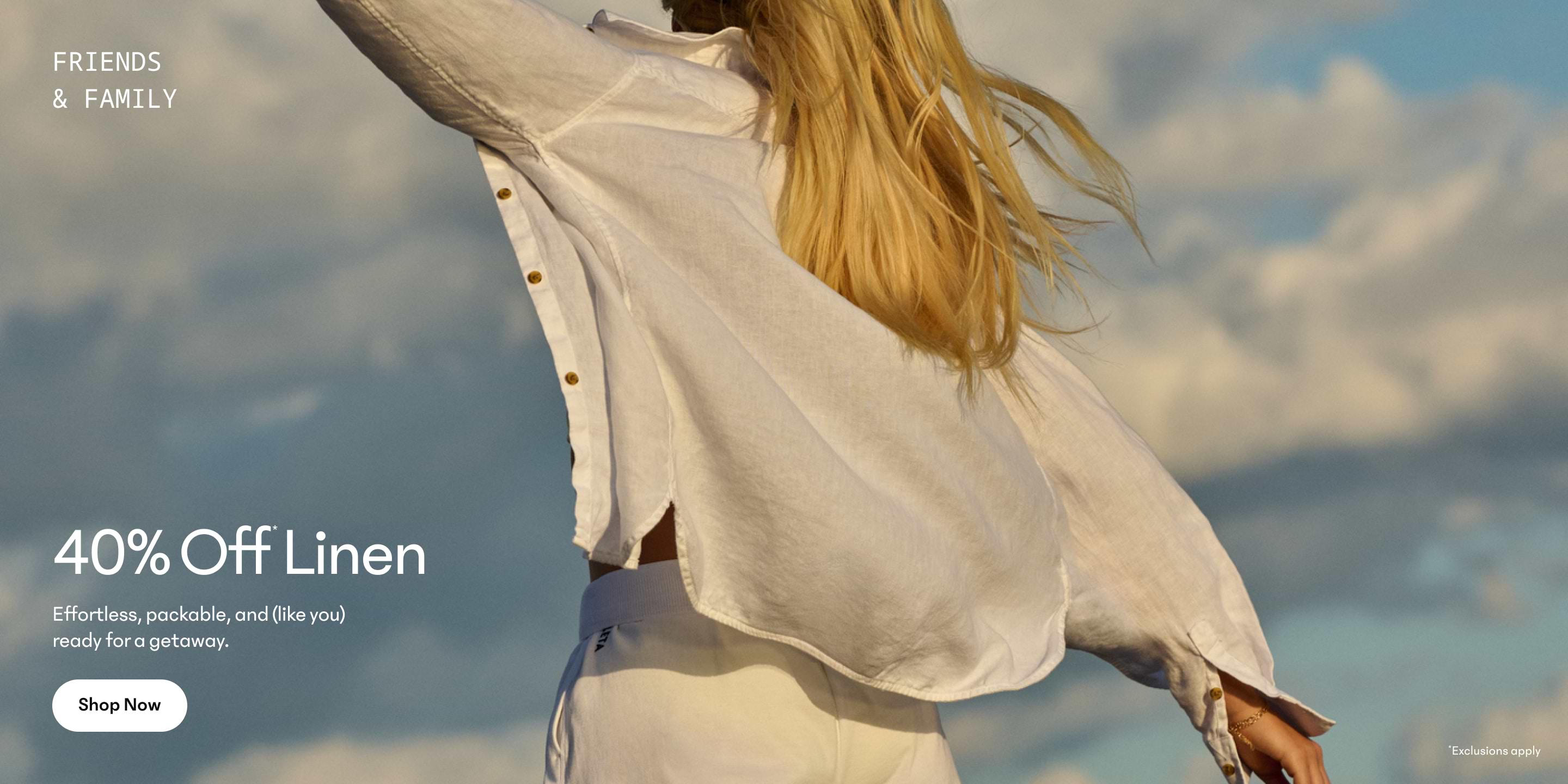 a woman in white shirt with long blonde hair flying in the air
