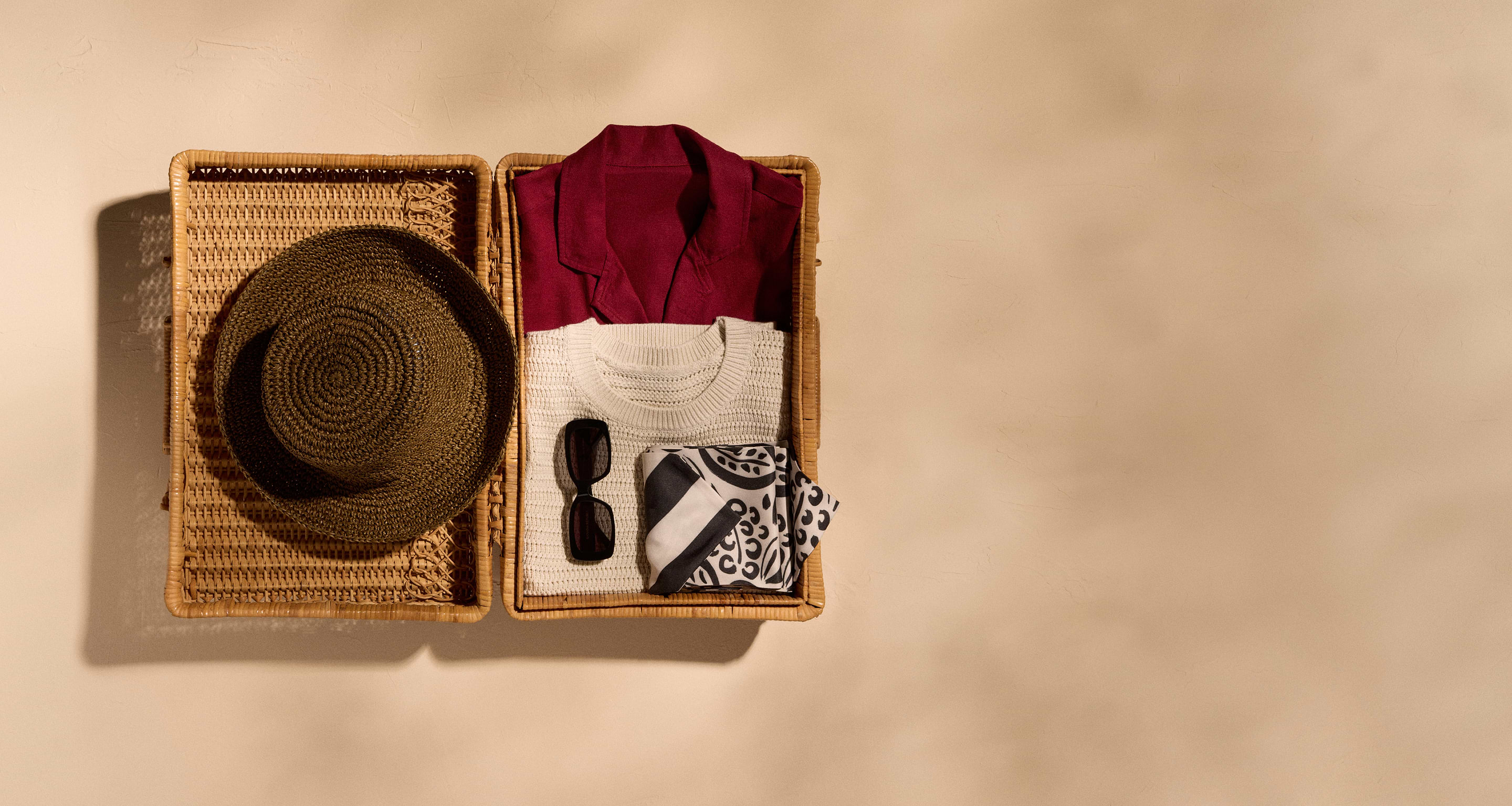Image of apparel and accessories in a straw basket.