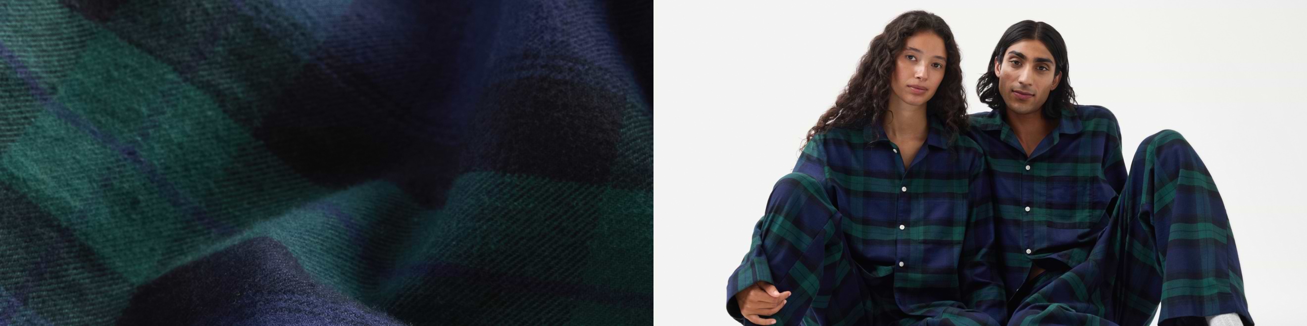 Close-up of navy and green plaid flannel; two people in matching plaid pajama sets sit together against a white background.