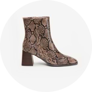 Side view of brown snake-print ankle boot with block heel.