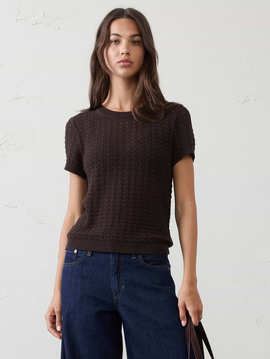 Woman in brown top and jeans.