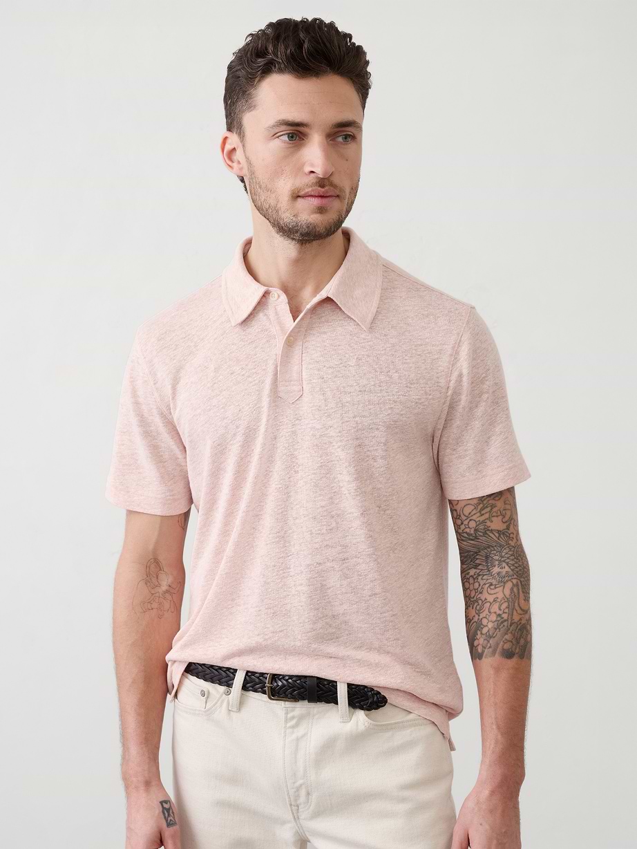 Man in pink polo and white pants.