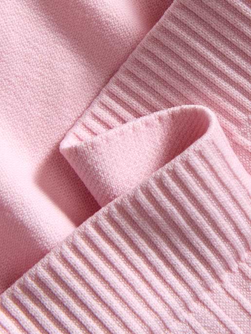 Close-up of light pink knit fabric with a folded ribbed cuff.