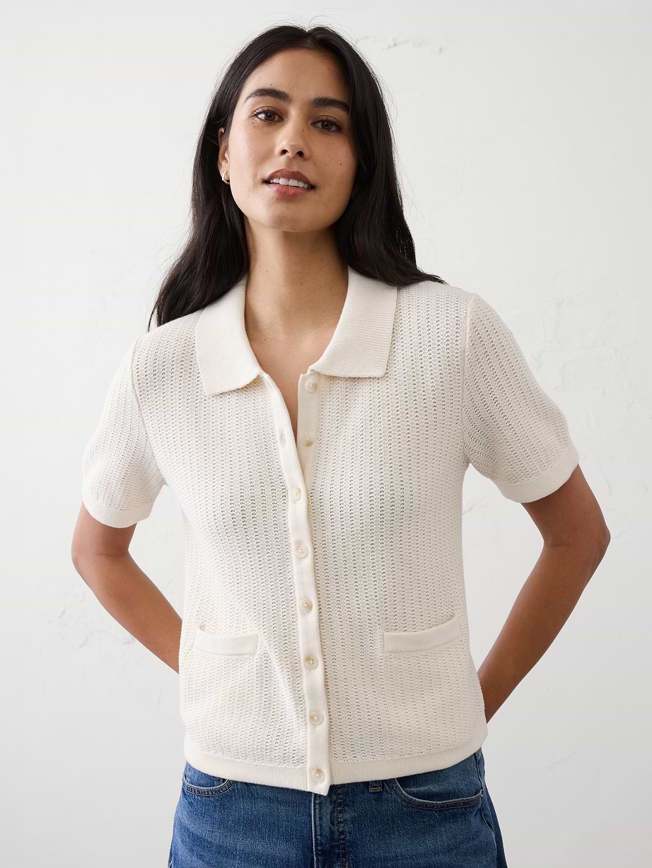 Woman in white sweater top and jeans.