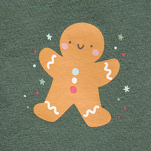 Smiling gingerbread cookie illustration with icing and colorful sprinkles on green fabric.