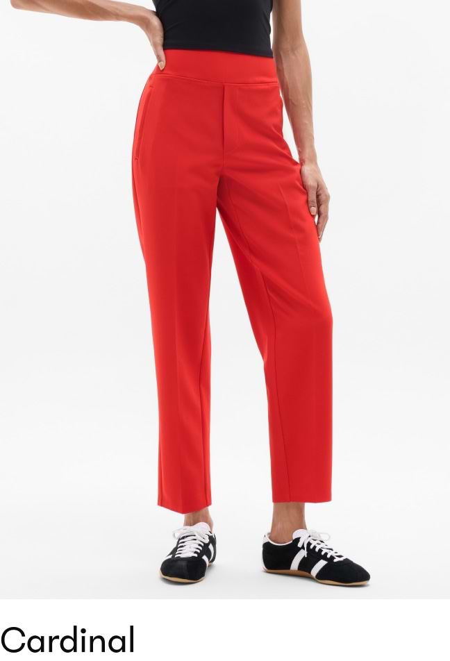 Cardinal red high-waisted straight-leg ankle pants on a model with black sneakers.