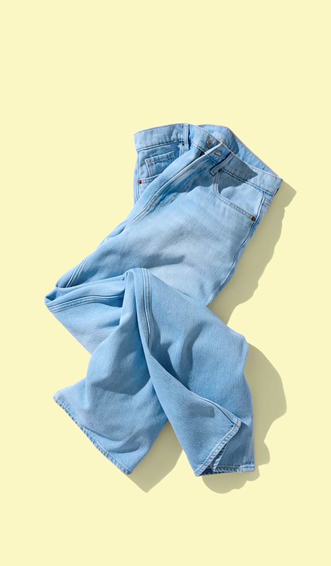 A single pair of folded light wash jeans.