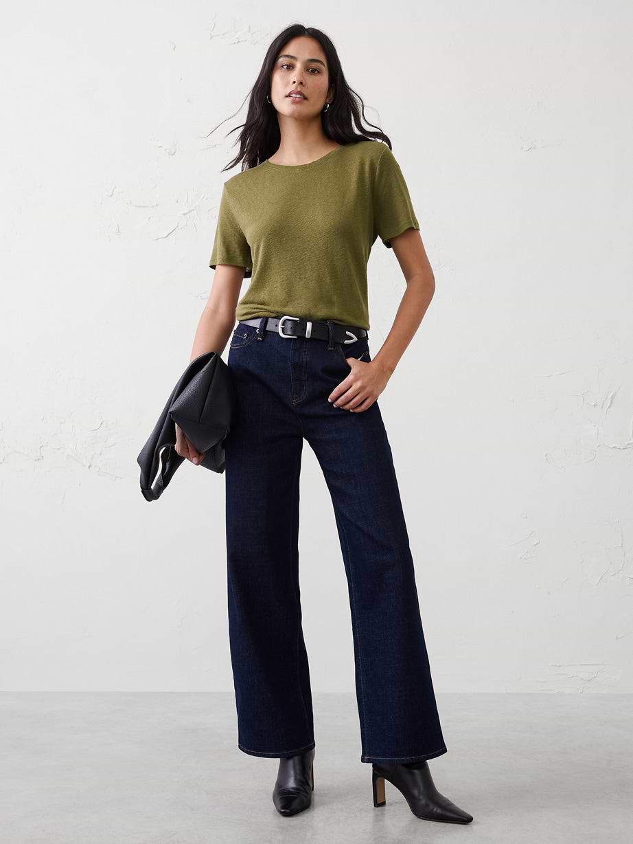 Woman in green t-shirt and jeans. 