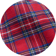 Close-up of red tartan plaid fabric with blue, white, and yellow stripes.