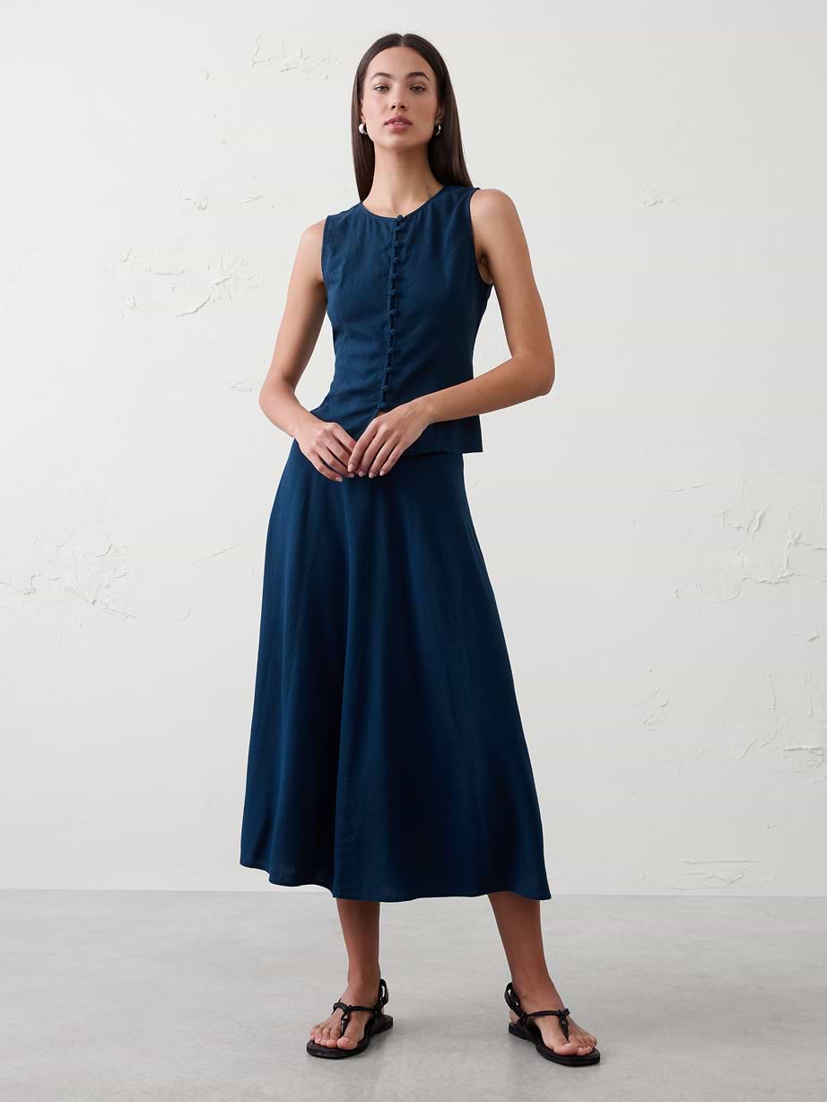 Woman in blue top and matching skirt. 