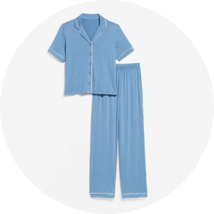 Light blue pajama set with short-sleeve button-up top and white piping, paired with matching long pants.