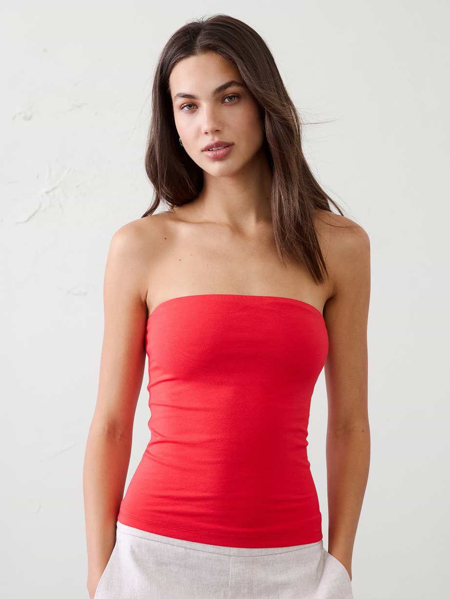 Woman in red top and white shorts.
