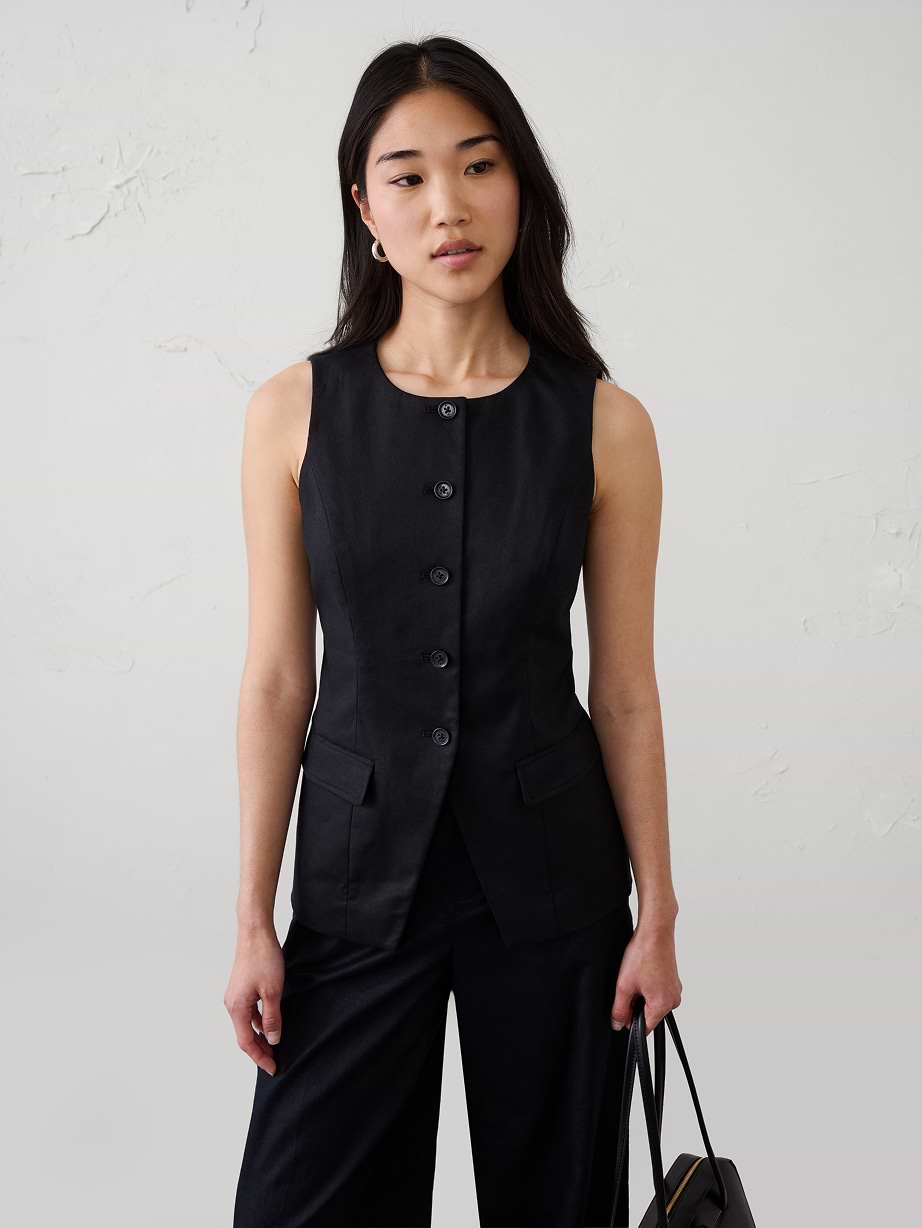 Woman in black vest and black pants.