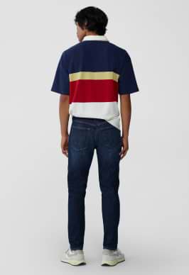 A male model wearing athletic taper jeans.