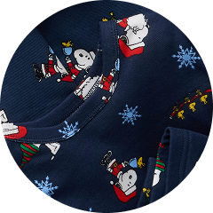 Close-up of navy pajamas with Snoopy holiday print and blue snowflakes.