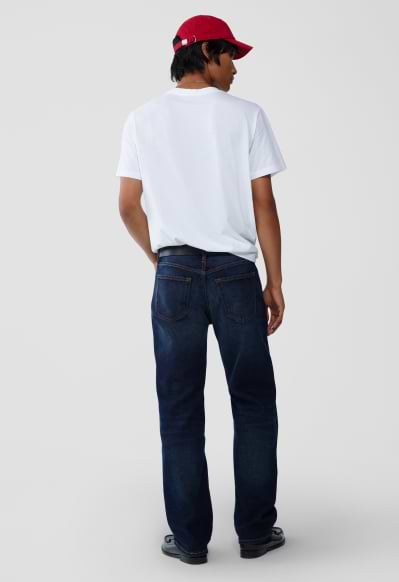 A male model wearing loose jeans.