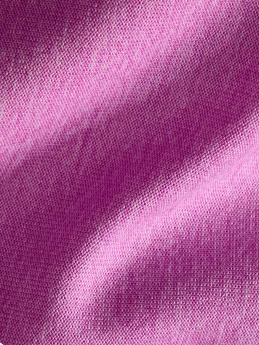 Close-up of pink woven fabric with soft folds and subtle shadows.