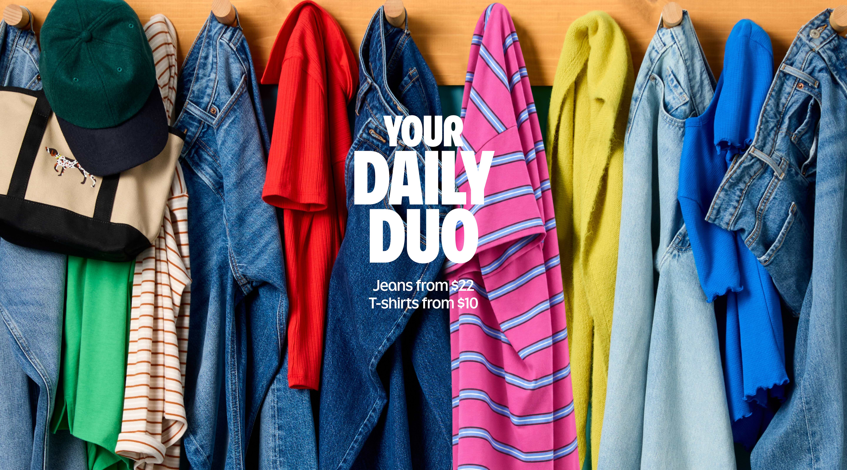Colorful jeans and T-shirts hanging on wooden hooks with the text: “Your Daily Duo — Jeans from $22, T-shirts from $10.”