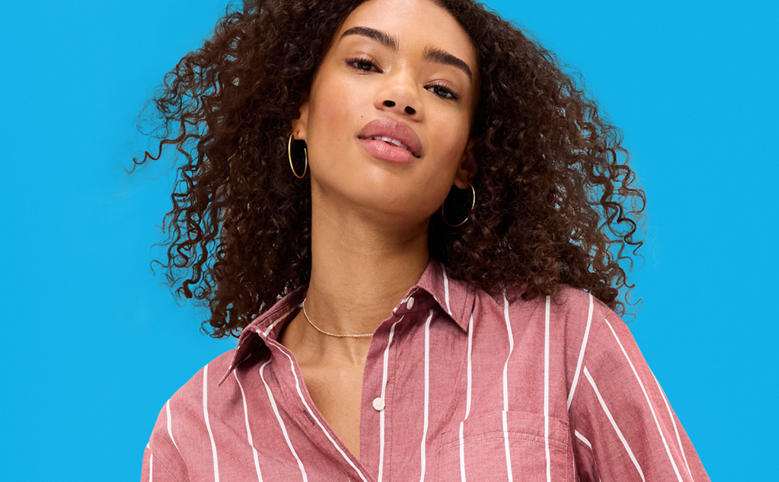 Image of a female model wearing a red stiped blouse.