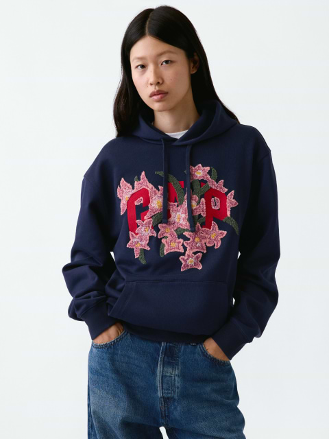 a model wearing a sweatshirt with flowers on it