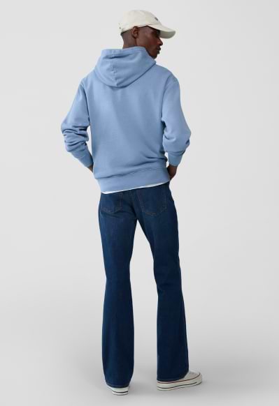 A male model wearing boot-cut jeans.