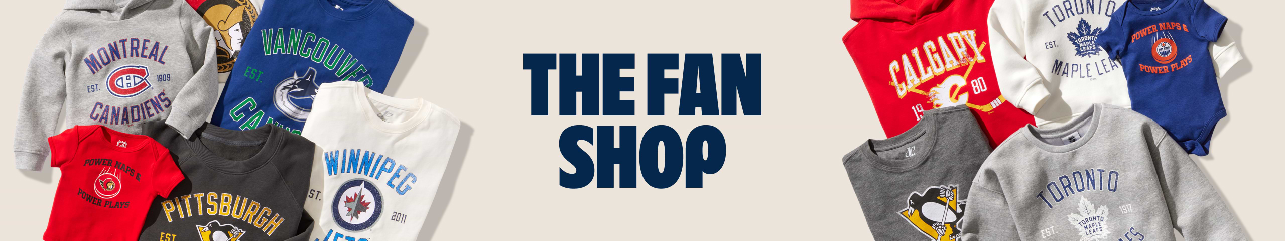 Alt text: “The Fan Shop banner surrounded by NHL team sweatshirts and a baby onesie.”